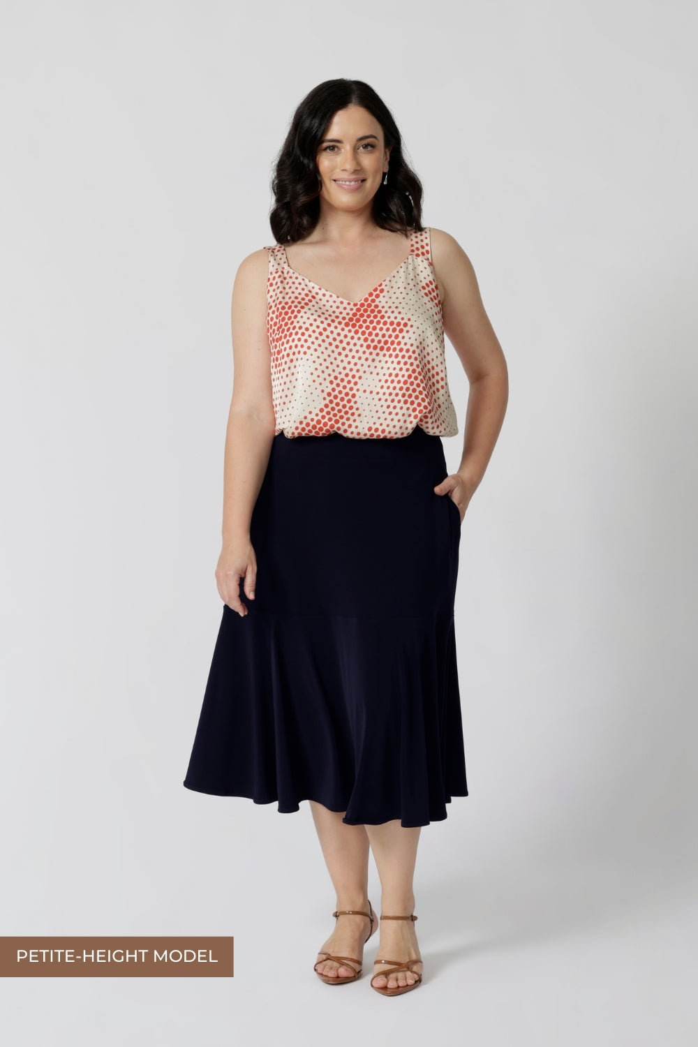 A navy blue, below-the-knee-length skirt with ruffle hemline. A pull-on skirt in stretch jersey fabric, this is a comfortable skirt for all-day work wear.