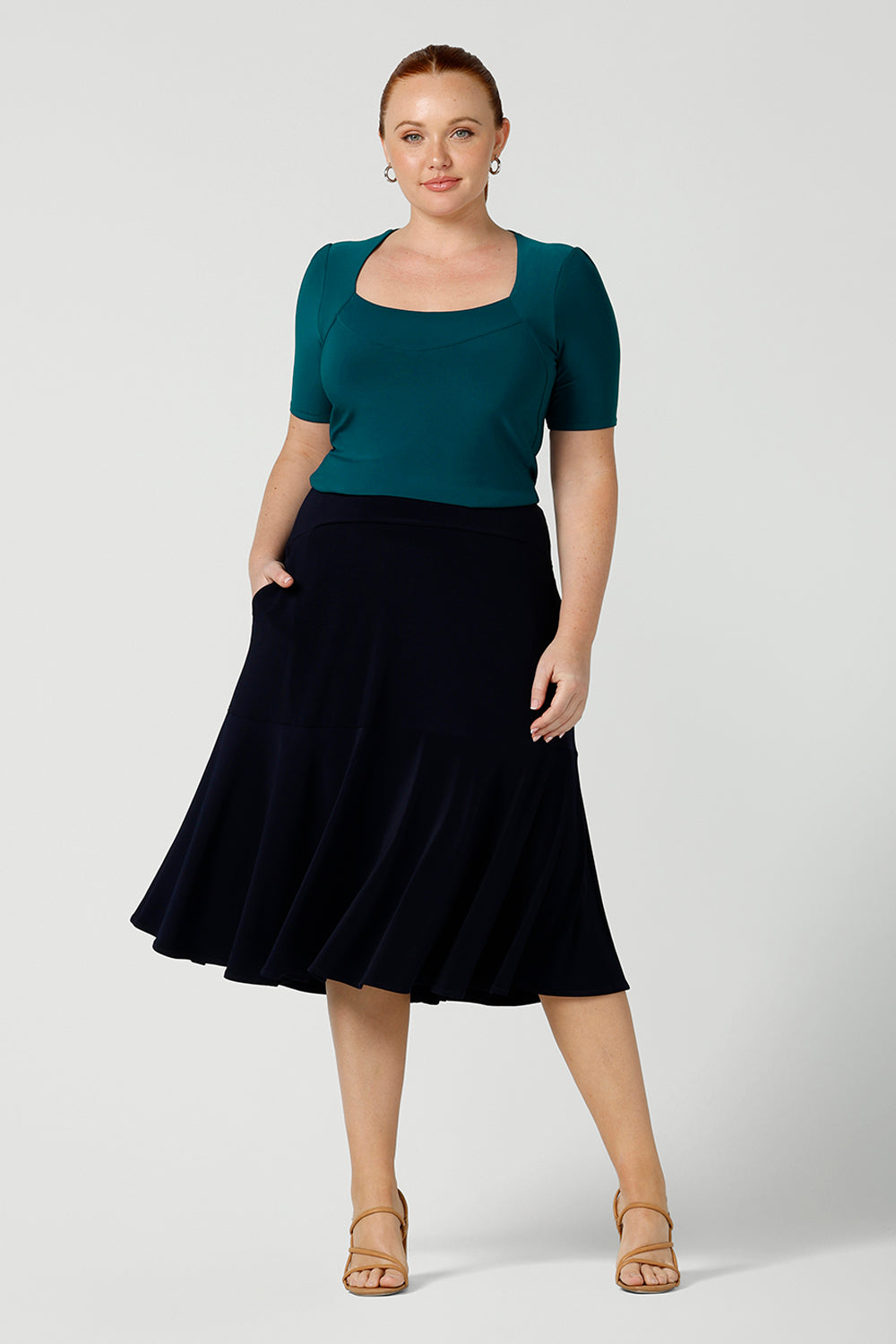 A great example of Australian-made skirts, this navy blue knee-length skirt in comfortable jersey fabric is worn with a fitted short sleeve top in teal. Available from Australian ladies clothing brand, Leina & Fleur, this classic navy skirt is available as petite to plus size office wear in their online boutique.