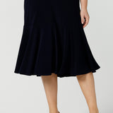 A great example of Australian-made skirts, this navy blue knee-length skirt in comfortable jersey fabric is shown in a size 12 as workwear for curvy women. Available from Australian ladies clothing brand, Leina & Fleur, this classic navy skirt is available as petite to plus size office wear in their online boutique.