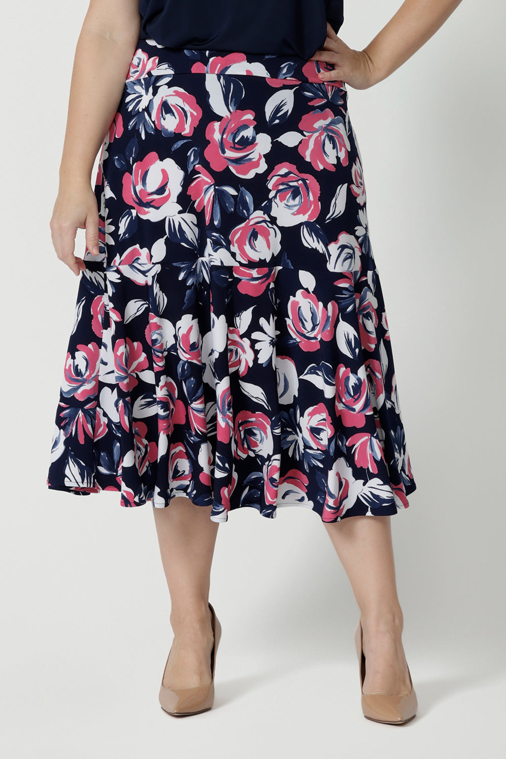 Close up front on image of printed wide midi length skirt, made of easy to care dry touch jersey. Floral pant shows roses in pink, white and navy. Easy to care fabric is used to craft Australian made garments for woman in Australia and New Zealand. Leina & Fleur is size inclusive brand, proudly stocking sizes ranging from 8 to 24. 