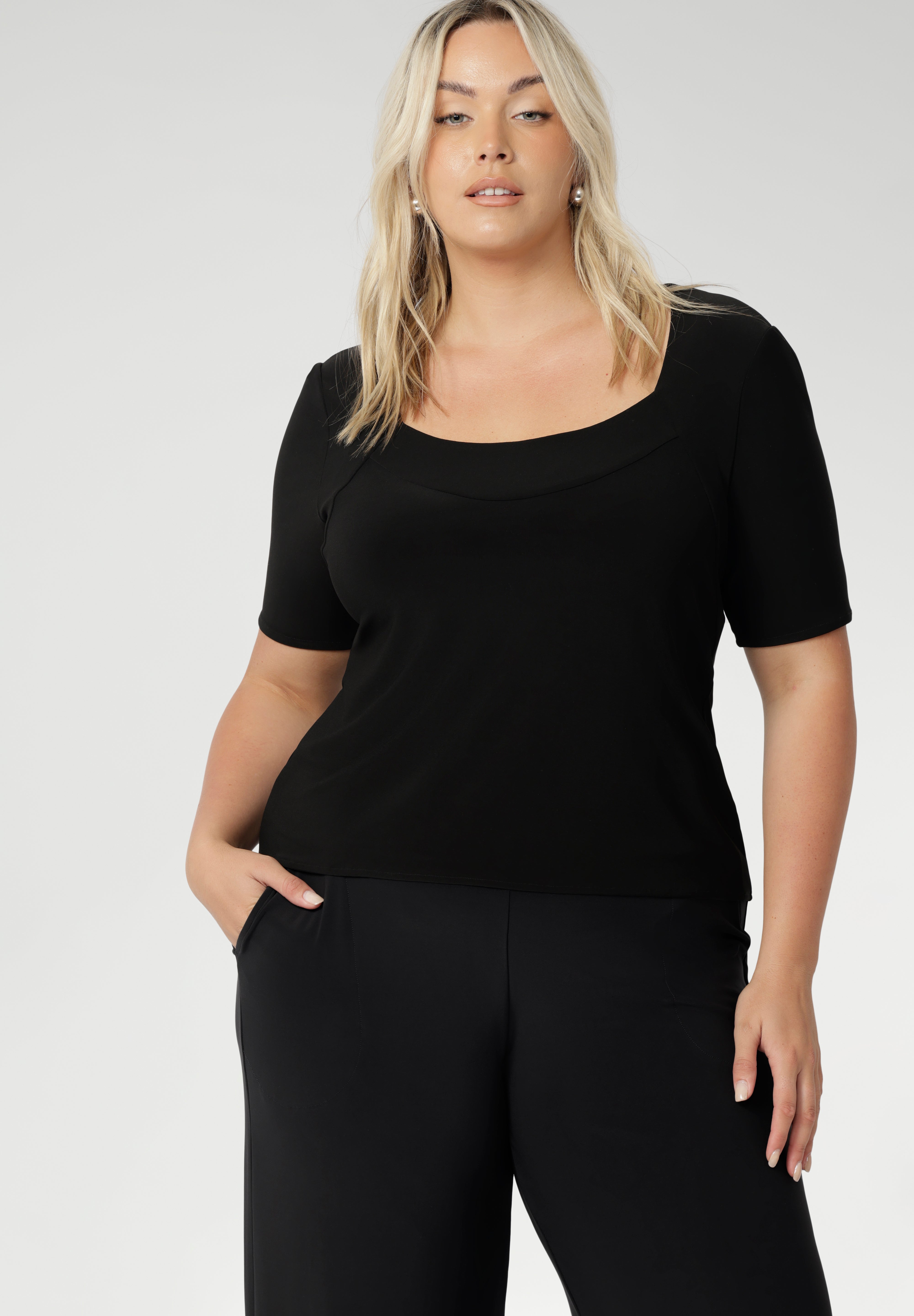 Elevate your wardrobe with this short sleeve black jersey top, designed for women over 30 who value both style and versatility. Featuring a flattering square neckline and a slim, tailored fit, this classic black top transitions effortlessly from office to off-duty. Perfectly paired with workwear separates for a polished professional look or styled with denim for elevated smart-casual dressing. Shop this essential women’s top online at Australian fashion label Leina + Fleur, available in inclusive sizes 8–24