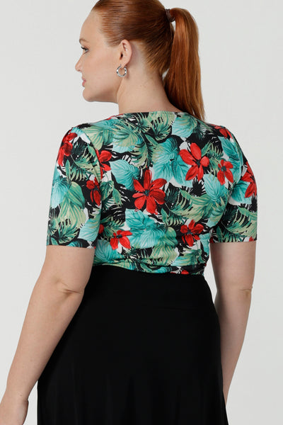 Back view of a size 12 curvy woman wears the Berni Top in Havana print. Square neckline with neck band and sleeve head tuck. Beautiful tropical print with red flowers and green palm leaves. Made in Australia for women size 8 - 24.