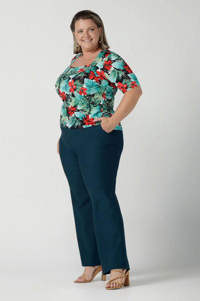 Size 18 curvy woman wears the Berni Top in Havana print. Square neckline with neck band and sleeve head tuck. Beautiful tropical print with red flowers and green palm leaves. Made in Australia for women size 8 - 24.