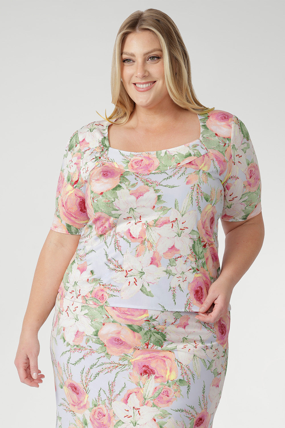 The squared scoop neckline and structured bust offer a refined, modern shape, while the short sleeves with delicate tucks at the sleeve-head add subtle detail and elegance.