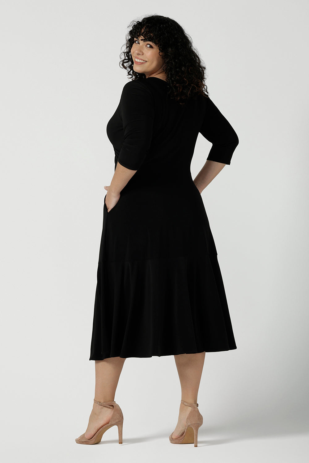 Back view of a close up of a size 16 Woman wears a Bettina Petite Reversible dress in black. A reversible dress for stylish casual wear. Soft stretch jersey with pockets and a wrap top. Made in Australia for women. Size 8 - 24.