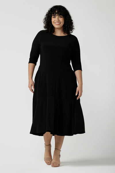 Reverse side of the Bettina dress in black, a size 16 Woman wears a Bettina Petite Reversible dress in black. A reversible dress for stylish casual wear. Soft stretch jersey with pockets and a wrap top. Made in Australia for women. Size 8 - 24.