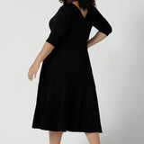 Reverse side of the Bettina dress in black, a size 16 Woman wears a Bettina Petite Reversible dress in black. A reversible dress for stylish casual wear. Soft stretch jersey with pockets and a wrap top. Made in Australia for women. Size 8 - 24.