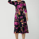 A size 10 Woman wears the Bettina Petite Reversible dress the Celeste print. It is a fixed wrap style with pockets and frill detail. A great work to wedding dress for women size 8 - 24. This is the dress featured on the reverse.