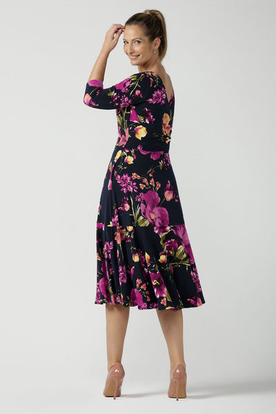 A size 10 Woman wears the Bettina Petite Reversible dress the Celeste print. It is a fixed wrap style with pockets and frill detail. A great work to wedding dress for women size 8 - 24. This is the dress featured on the reverse.