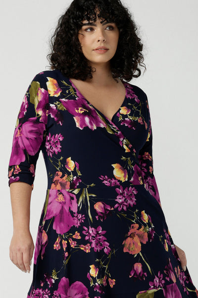A size 18 Woman wears the Bettina Petite Reversible dress the Celeste print. It is a fixed wrap style with pockets and frill detail. A great work to wedding dress for women size 8 - 24. 