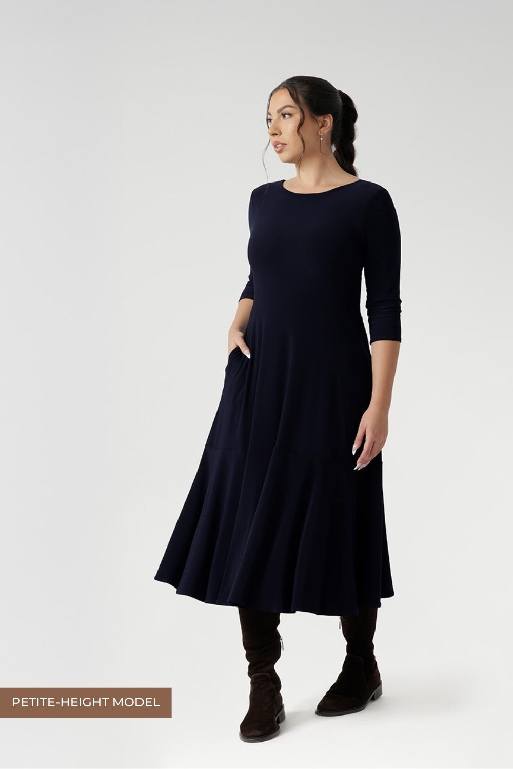 Reverse side of dress worn by size 10 petite height woman in Navy dry touch jersey. Stylish workwear dresses for women. Midi length with functional pockets, and can be reversed for a choice of v neckline or boat neck. Made in Australia for women size 8 - 24.