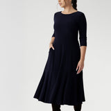 Reverse side of dress worn by size 10 petite height woman in Navy dry touch jersey. Stylish workwear dresses for women. Midi length with functional pockets, and can be reversed for a choice of v neckline or boat neck. Made in Australia for women size 8 - 24.
