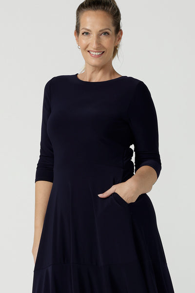 Close up of a petite-height, 3/4 sleeve reversible wrap dress in navy jersey worn with a V neck. Made in Australia by Australian and New Zealand women's clothing label, L&F and available in sizes 8 to 24.