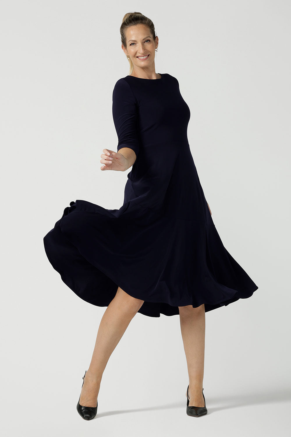 Reverse side of a petite-height, 3/4 sleeve reversible wrap dress in navy jersey worn with a V neck. Made in Australia by Australian and New Zealand women's clothing label, L&F and available in sizes 8 to 24.