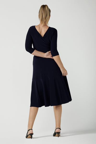 Reverse back view of a petite-height, 3/4 sleeve reversible wrap dress in navy jersey worn with a V neck. Made in Australia by Australian and New Zealand women's clothing label, L&F and available in sizes 8 to 24.