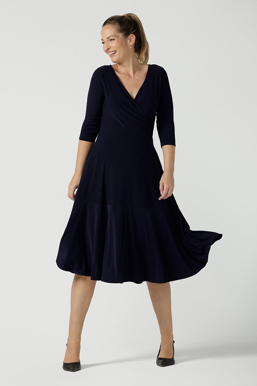 A petite-height, 3/4 sleeve reversible wrap dress in navy jersey worn with a V neck. Made in Australia by Australian and New Zealand women's clothing label, L&F and available in sizes 8 to 24.