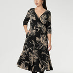 Details such as side pockets, skirt lining, and a double-layer boat neck bodice enhance both comfort and structure. Petite Height Model showcases the reversible dress in reverse.