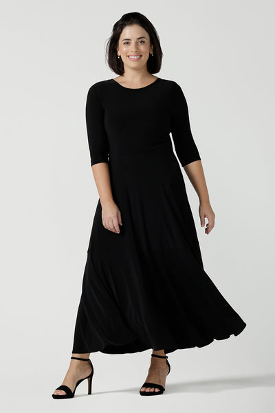 Size 10 woman wears a black reversible dress. Black jersey dress with black heels. Made in Australia for women size 8 - 24. Comfortable easy care jersey. Made in Australia for women size 8 - 24.