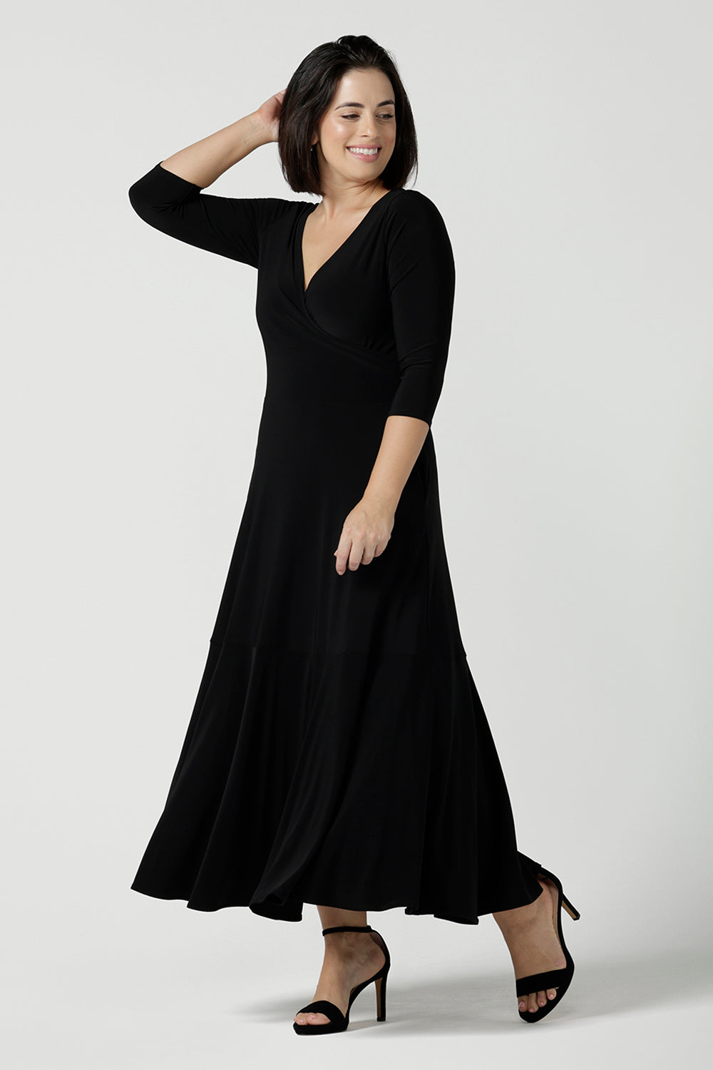 Size 10 woman wears a black reversible dress. Black jersey dress with black heels. Made in Australia for women size 8 - 24. Comfortable easy care jersey. Made in Australia for women size 8 - 24.