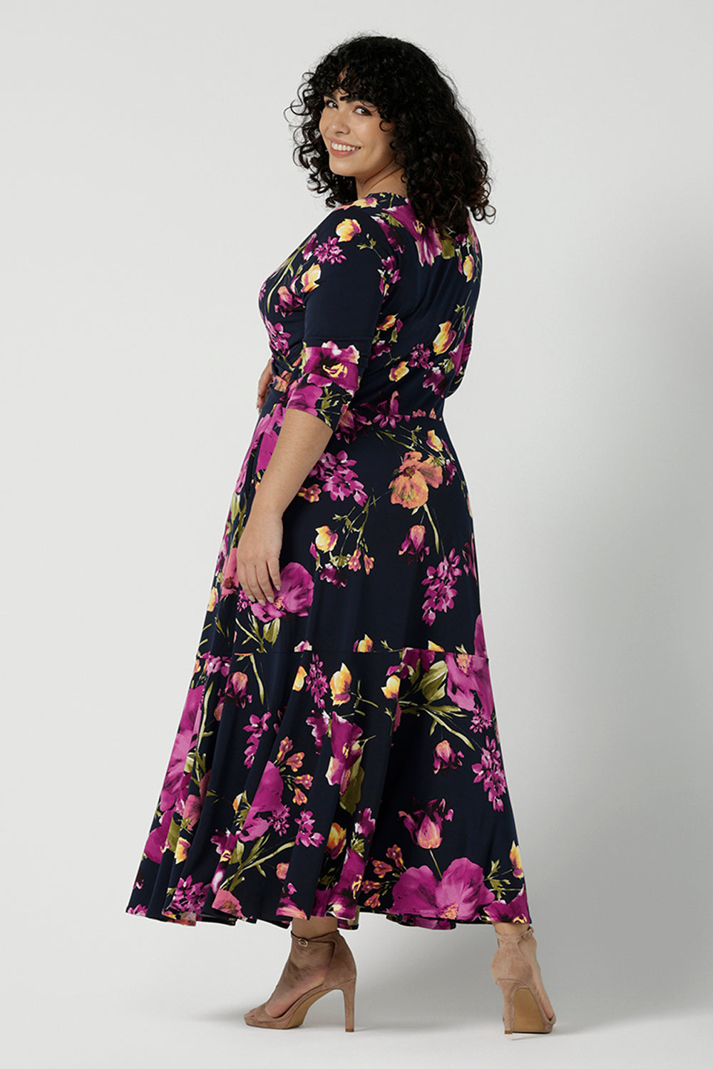 Back view of a size 18 woman wears the Bettina Reversible dress in Celeste. Fixed wrap style with pockets and v-neckline. Wear it multiple ways and reversible. Made in Australia for women size 8 - 24.