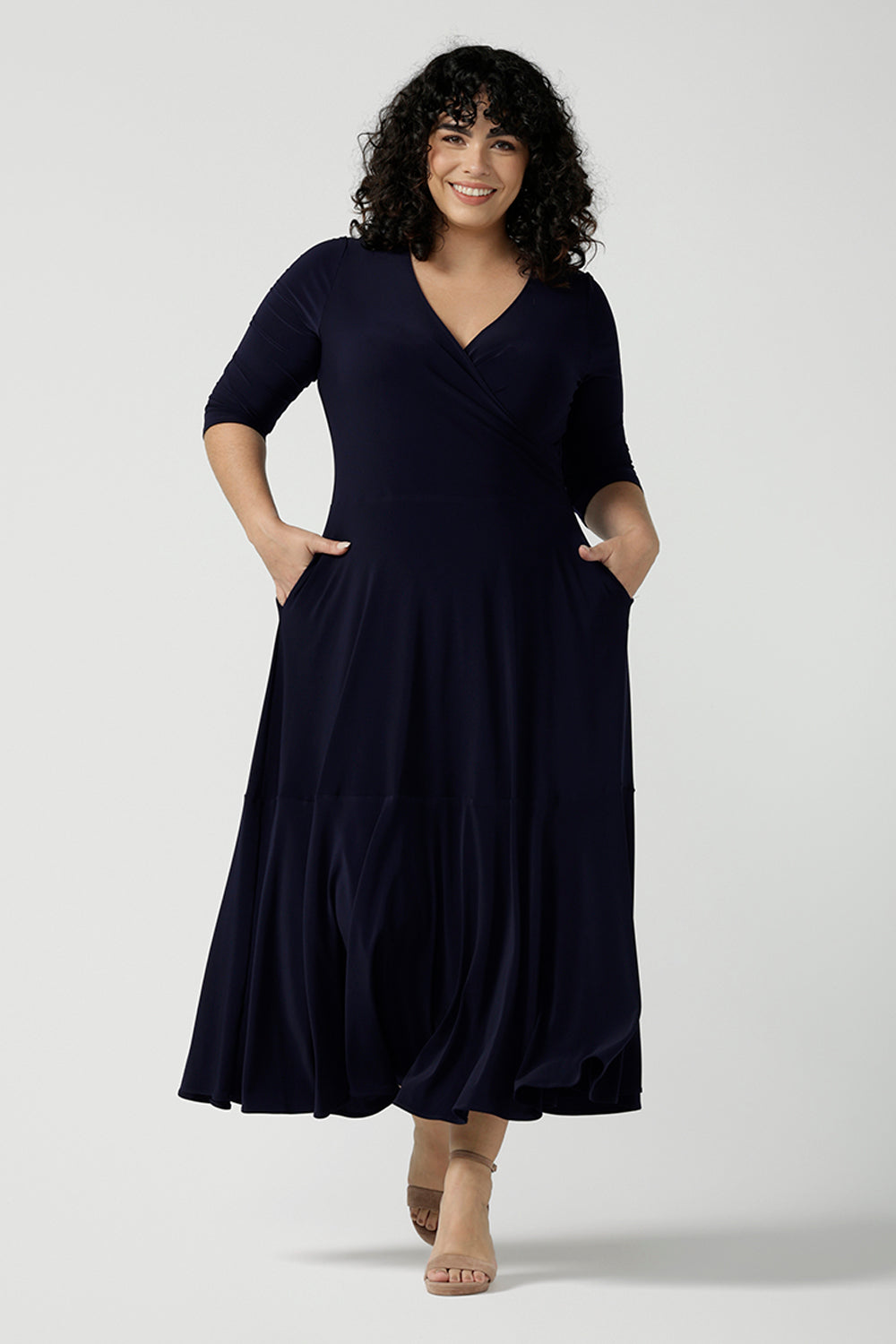 Size 18 woman wears a Bettina Reversible dress in Navy. Stylish workwear for women. Midi length with functional pockets. Made in Australia for women size 8 - 24.  Soft Navy jersey fabric. 