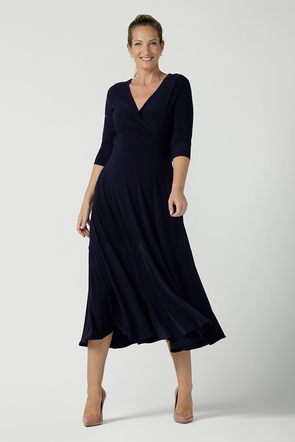 Size 10 woman wears a Bettina Reversible dress in Navy. Stylish workwear for women. Midi length with functional pockets. Made in Australia for women size 8 - 24. Soft Navy jersey fabric.