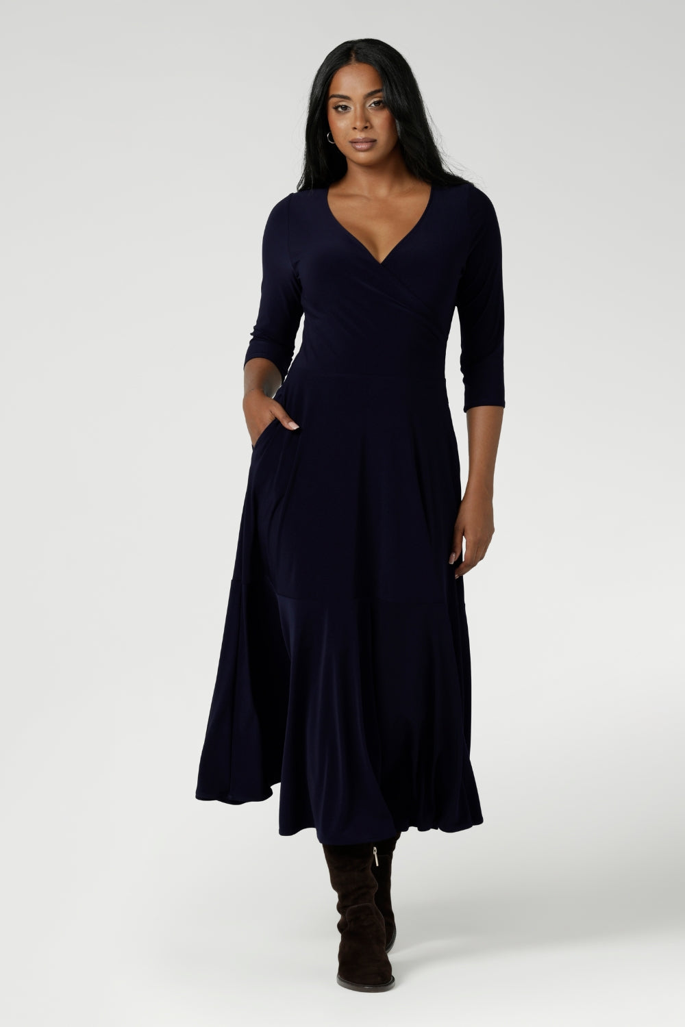Size 10 woman wears a Bettina Reversible dress in Navy. Stylish workwear for women. Midi length with functional pockets. Made in Australia for women size 8 - 24. Soft Navy jersey fabric.
