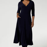 Size 10 woman wears a Bettina Reversible dress in Navy. Stylish workwear for women. Midi length with functional pockets. Made in Australia for women size 8 - 24. Soft Navy jersey fabric.