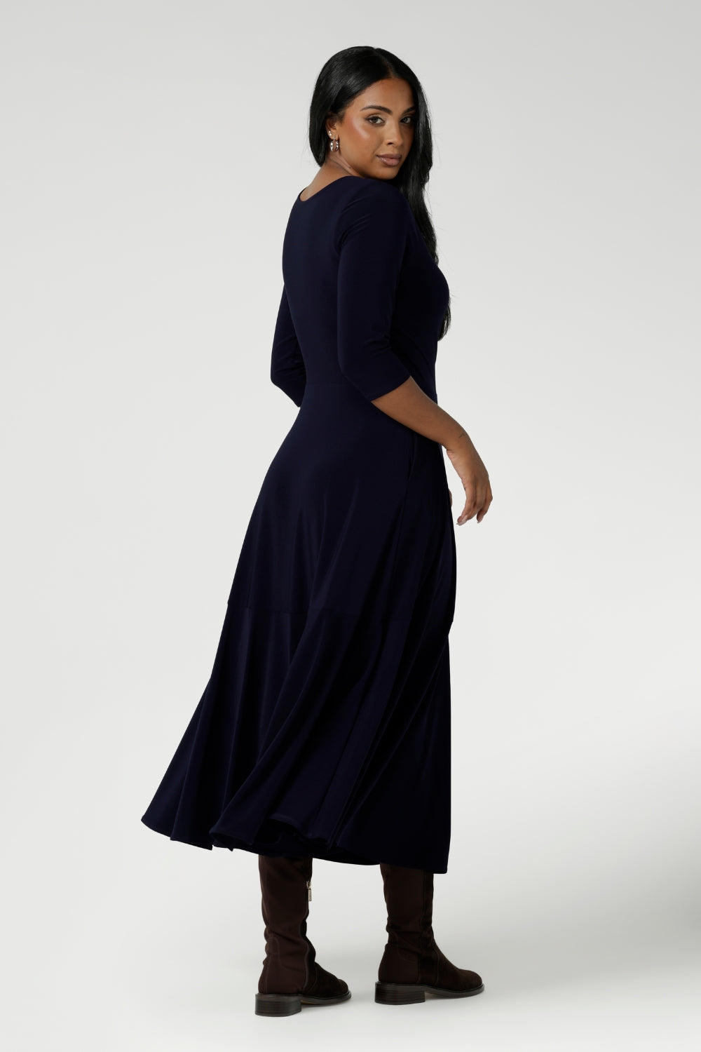 Back view of a size 10 woman wears a Bettina Reversible dress in Navy. Stylish workwear for women. Midi length with functional pockets. Made in Australia for women size 8 - 24. Soft Navy jersey fabric.