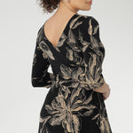 Designed with 3/4 length sleeves and a flowing maxi-length skirt with a soft ruffle hem, this piece offers ease of movement and timeless appeal. Thoughtful details such as side pockets, skirt lining, and a double-layer boat neck bodice enhance both comfort and structure.