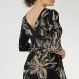Designed with 3/4 length sleeves and a flowing maxi-length skirt with a soft ruffle hem, this piece offers ease of movement and timeless appeal. Thoughtful details such as side pockets, skirt lining, and a double-layer boat neck bodice enhance both comfort and structure.