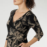 3/4 length sleeves and a flowing maxi-length skirt with a soft ruffle hem, this piece offers ease of movement and timeless appeal. Thoughtful details such as side pockets, skirt lining, and a double-layer boat neck bodice enhance both comfort and structure. Available in both regular and petite sizes.