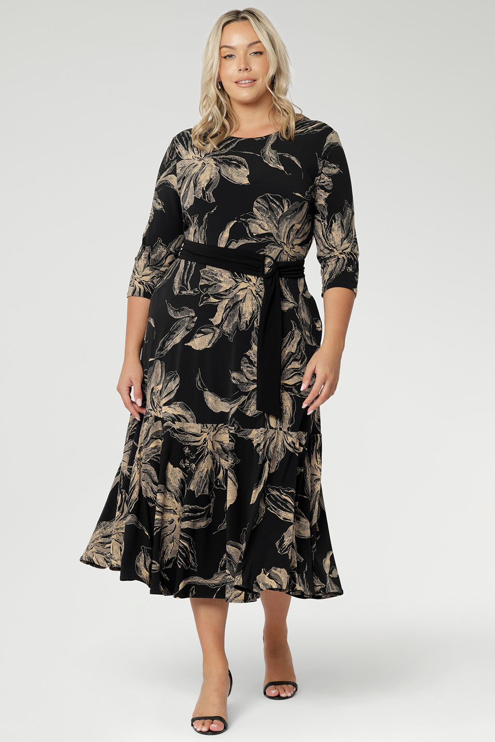 Crafted from our signature black dry-touch stretch jersey, this versatile midi dress is designed to deliver both style and function. Plus size model wears reversible dress with boat neckline and black belt to cinch at the waist.