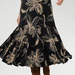 Flowy maxi-length skirt with a soft ruffle hem, this piece offers ease of movement and timeless appeal. Thoughtful details such as side pockets, skirt lining, and a double-layer boat neck bodice enhance both comfort and structure.