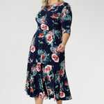 Crafted from a soft-stretch, dry-touch jersey fabric, the Vintage Rose print features delicate floral detailing in shades of pink, red, and blue on a timeless navy background. The 3/4 length sleeves offer coverage with a touch of sophistication, while the flowing maxi skirt is finished with a ruffle hemline for added movement and flair. 