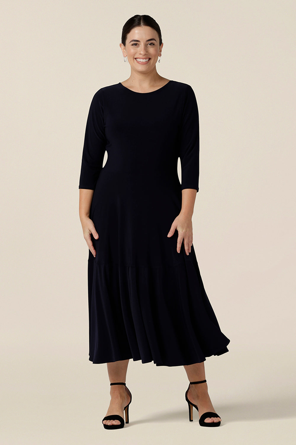 A petite-height, 3/4 sleeve reversible wrap dress in navy jersey worn with a boat neck. Made in Australia by Australian and New Zealand women's clothing label, L&F and available in sizes 8 to 24.