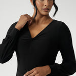 The Bianca Dress is a timeless black knee-length style designed for both work and special occasions. Featuring a sophisticated V-neckline with a twist-front bodice and cuffed long sleeves, it creates a flattering silhouette with elegant detail. Made in Australia from our signature dry-touch jersey fabric.