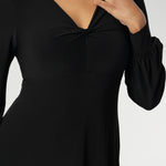 The Bianca Dress is a timeless black knee-length style designed for both work and special occasions. Featuring a sophisticated V-neckline with a twist-front bodice and cuffed long sleeves, it creates a flattering silhouette with elegant detail. Made in Australia from our signature dry-touch jersey fabric.