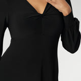 The Bianca Dress is a timeless black knee-length style designed for both work and special occasions. Featuring a sophisticated V-neckline with a twist-front bodice and cuffed long sleeves, it creates a flattering silhouette with elegant detail. Made in Australia from our signature dry-touch jersey fabric.