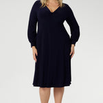 Featuring a sophisticated V-neckline with a twist-front bodice and cuffed long sleeves, it creates a flattering silhouette with elegant detail. Made in Australia from our signature dry-touch jersey fabric, it offers all-day comfort, stretch, and easy care. Available in sizes 8 to 24, this versatile piece is designed to flatter petite and plus-size women alike.