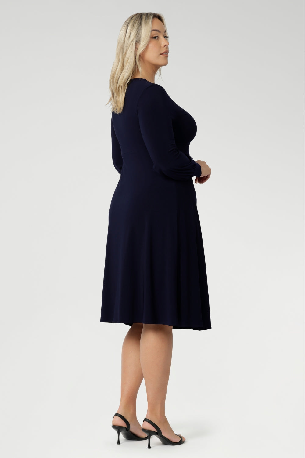 Available in sizes 8 to 24, this versatile piece is designed to flatter petite and plus-size women alike. Effortlessly layer it under a blazer or coat, or style it with stockings and boots during the cooler months for a chic, season-ready look.