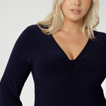 The Bianca Dress is a timeless black knee-length style designed for both work and special occasions. Featuring a sophisticated V-neckline with a twist-front bodice and cuffed long sleeves, it creates a flattering silhouette with elegant detail. Made in Australia from our signature dry-touch jersey fabric, it offers all-day comfort, stretch, and easy care.