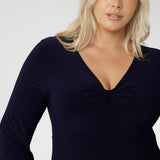 The Bianca Dress is a timeless black knee-length style designed for both work and special occasions. Featuring a sophisticated V-neckline with a twist-front bodice and cuffed long sleeves, it creates a flattering silhouette with elegant detail. Made in Australia from our signature dry-touch jersey fabric, it offers all-day comfort, stretch, and easy care.
