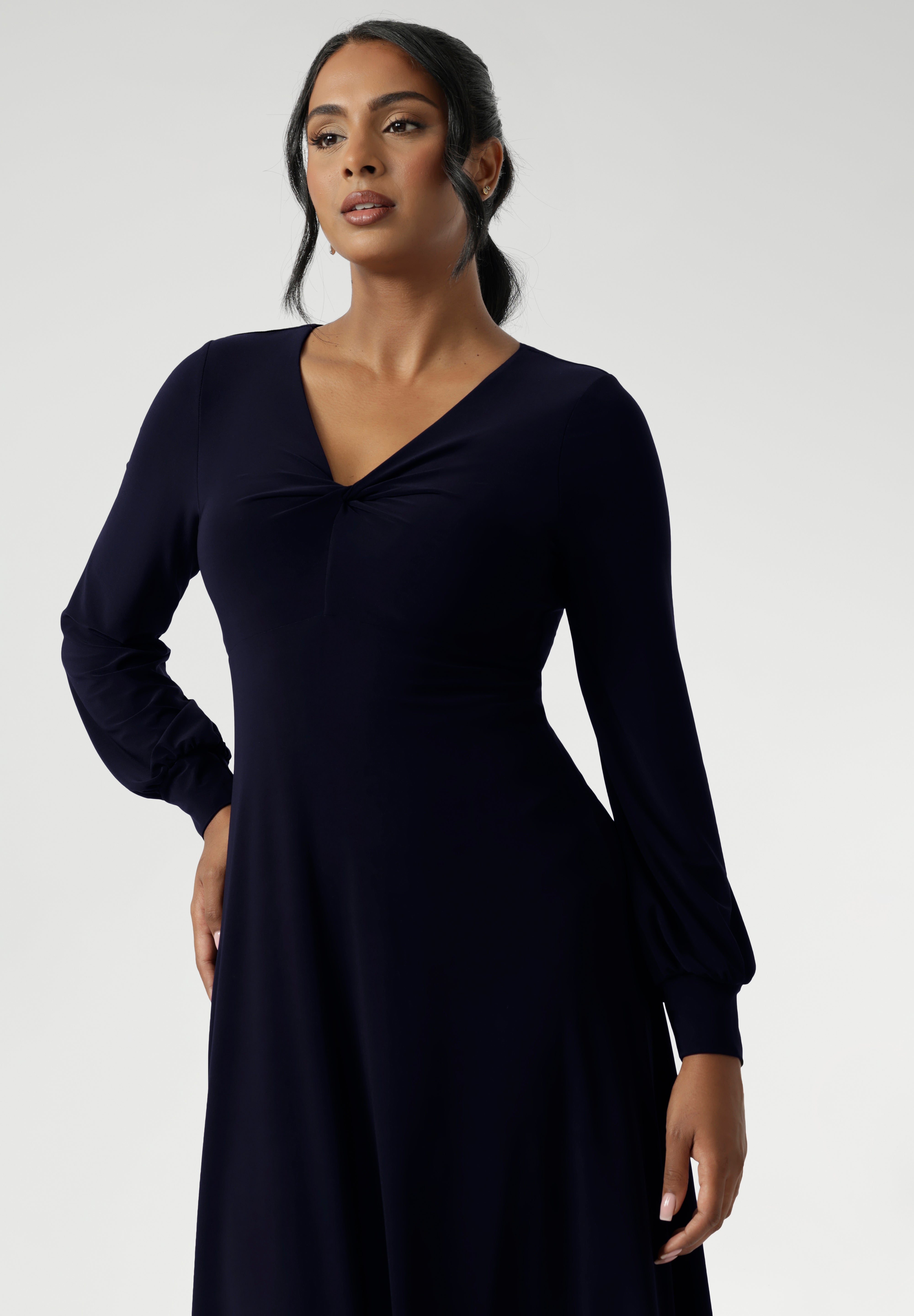 Featuring a sophisticated V-neckline with a twist-front bodice and cuffed long sleeves, it creates a flattering silhouette with elegant detail. Made in Australia from our signature dry-touch jersey fabric. Available in size 8-24. 