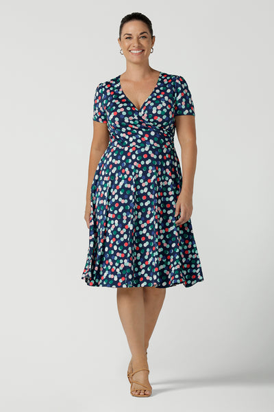 Curvy size 12 woman wears a Bubbles printed Jersey dress with a fixed wrap in a midi length. Perfect for work to weekend looks. Made in Australia for women size 8 - 24.