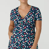 Close up of curvy size 12 woman wearing a Bubbles printed Jersey dress with a fixed wrap in a midi length. Perfect for work to weekend looks. Made in Australia for women size 8 - 24.