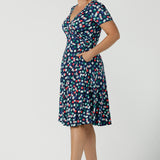 Curvy size 12 woman wears a Bubbles printed Jersey dress with a fixed wrap in a midi length. Perfect for work to weekend looks. Made in Australia for women size 8 - 24.