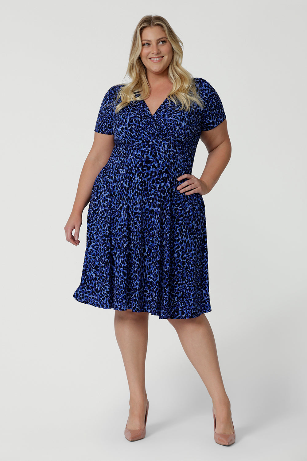 Showing a good wrap dress for plus size women, a curvy size 18 woman wears a short sleeve fixed wrap dress. An animal print wrap dress with short sleeves, this is a great summer dress. Shop wrap dresses Australia online at Leina & Fleur in sizes 8-24, petite to plus sizes.