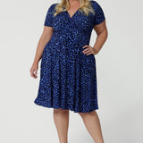 Showing a good wrap dress for plus size women, a curvy size 18 woman wears a short sleeve fixed wrap dress. An animal print wrap dress with short sleeves, this is a great summer dress. Shop wrap dresses Australia online at Leina & Fleur in sizes 8-24, petite to plus sizes.