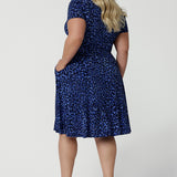 Back view of a good wrap dress for plus size women, a curvy size 18 woman wears a short sleeve fixed wrap dress. An animal print wrap dress with short sleeves, this is a great summer dress. Shop wrap dresses Australia online at Australian and New Zealand fashion brand, Leina & Fleur.